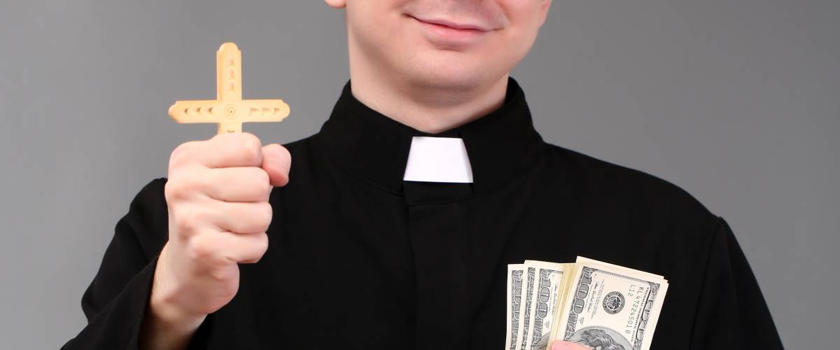 Young pastor with cross and money on gray background
