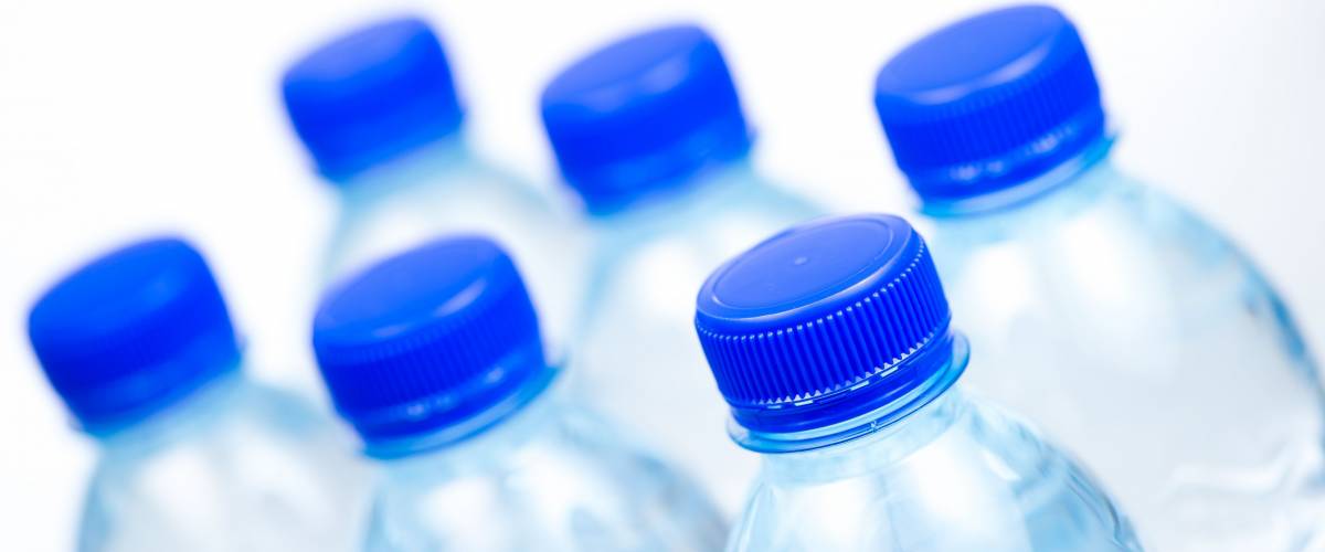 Plastic bottles of water isolated on white background, France