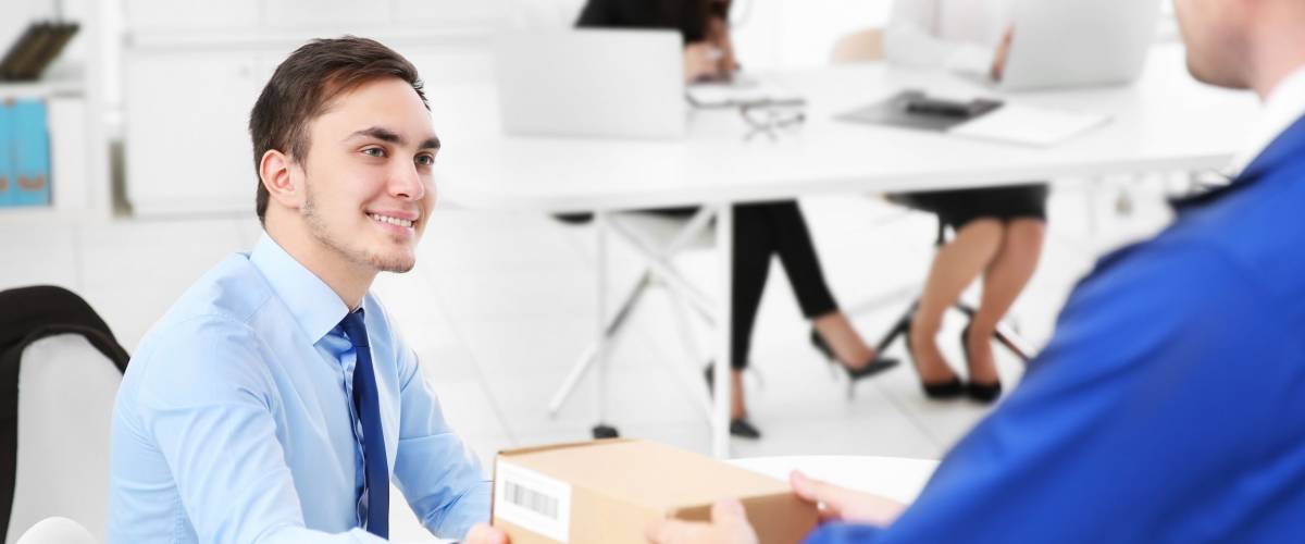 Courier delivering package in office