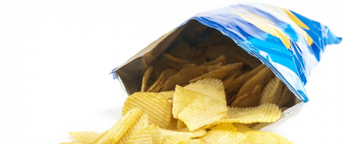 heap of potato crisps on white background