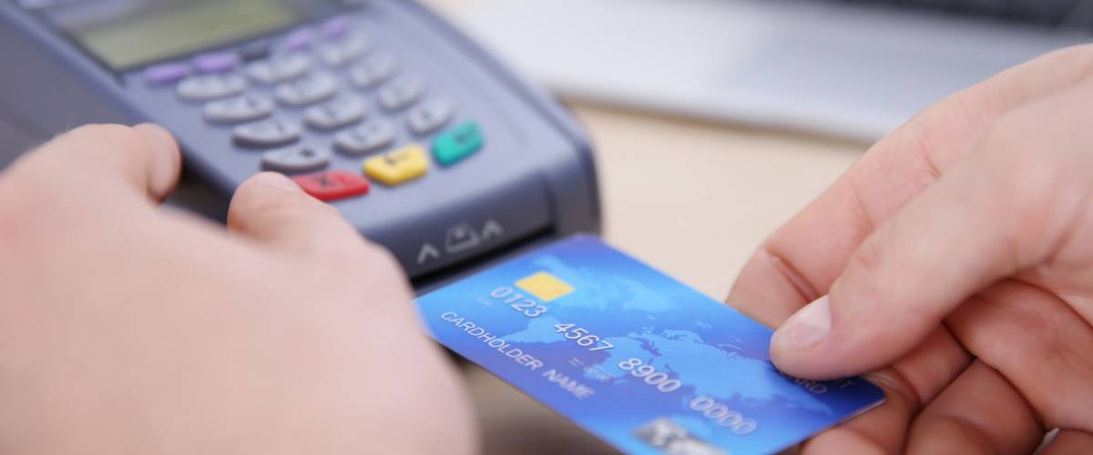 Businessman using payment terminal