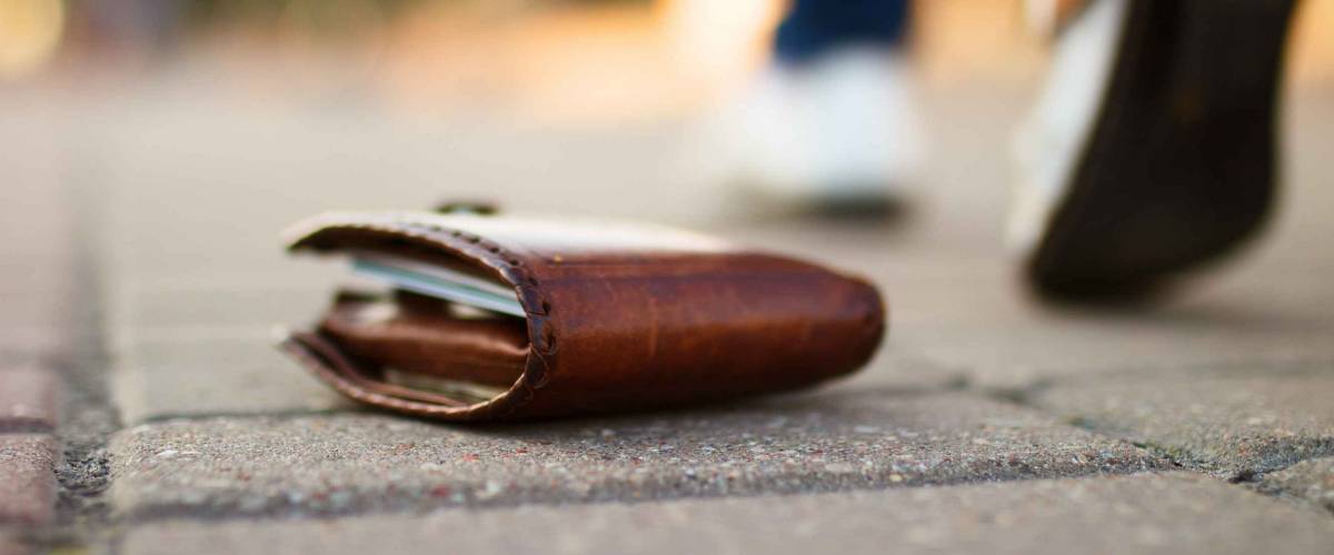 wallet with money lying on the ground