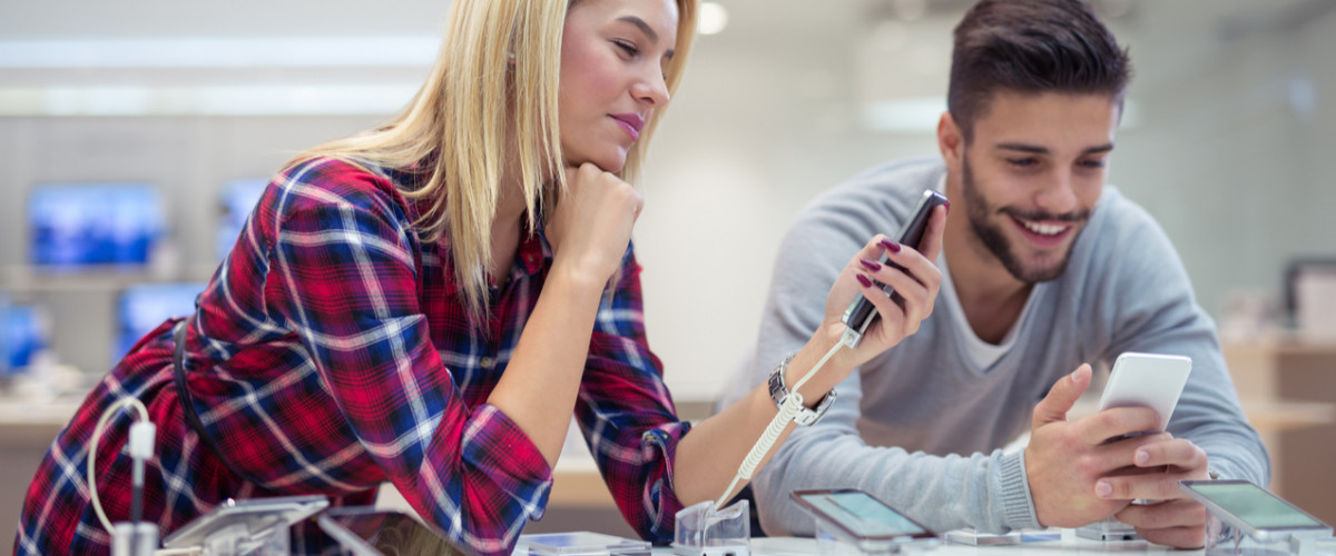 Young couple comparison shopping in an electronics store