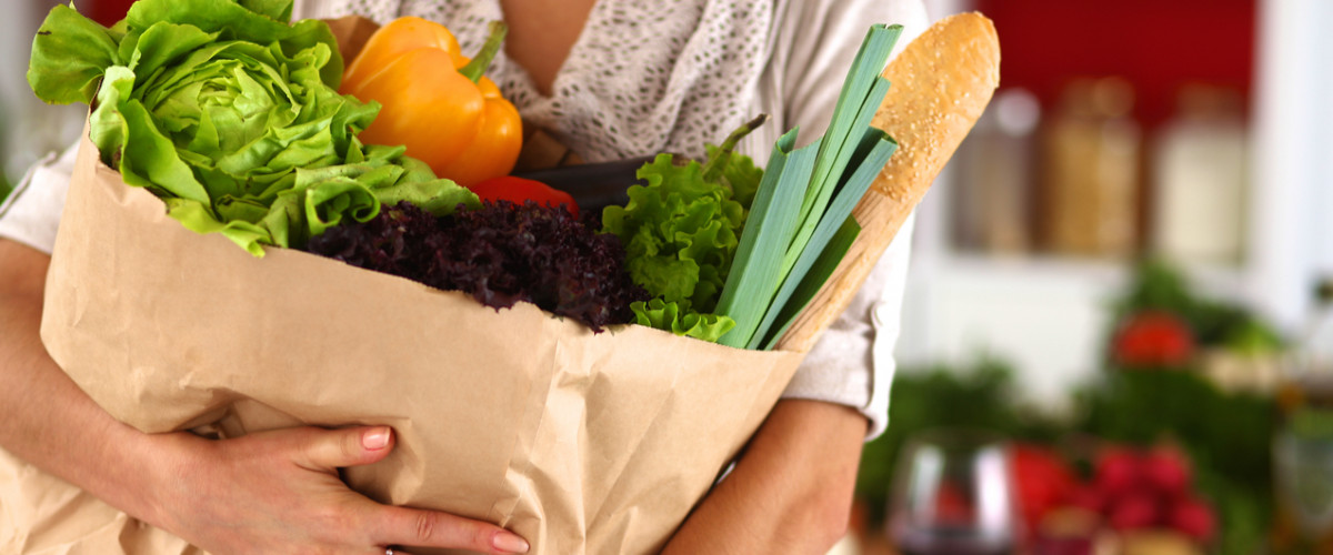 Woman holding a large bag of groceries