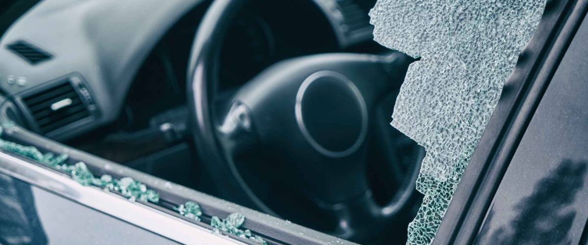 A criminal incident. Hacking the car. Broken left side window of a car