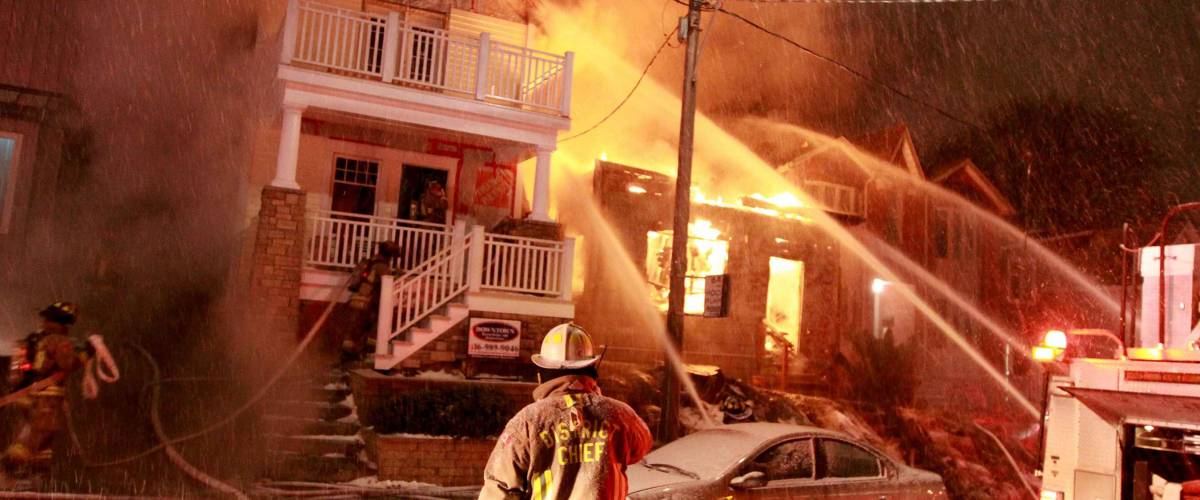 TORONTO - CIRCA JANUARY 2010 - Firefighters battle a four alarm fire involving three homes in the Beach neighborhood of the city.