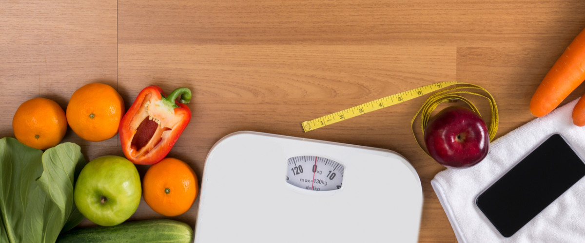 Fitness concept scale vegetables smartphone measuring tape