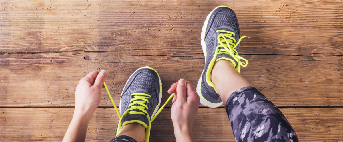 Young runner lacing shoes