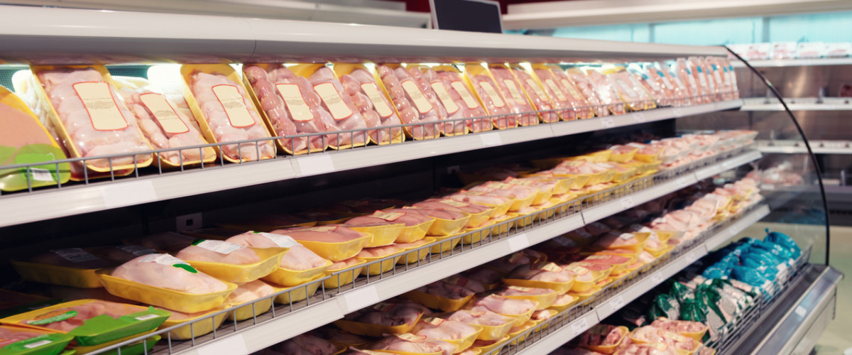 Fresh meat on display in grocery store fridge
