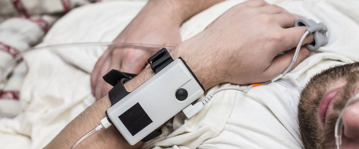 Sleep Apnea Diagnostic medical device Kit attached to the finger and the human nose, which lies in bed