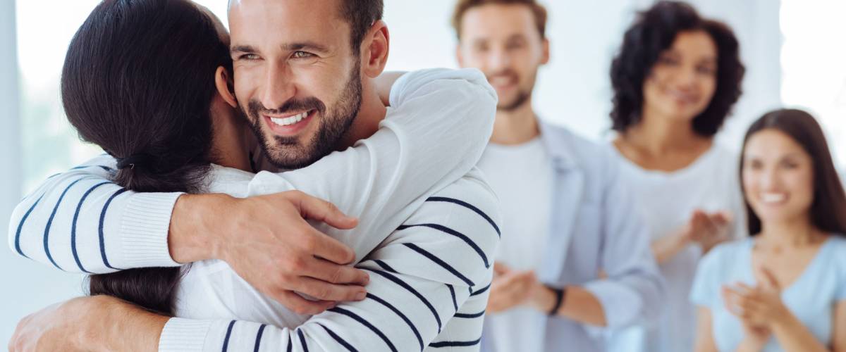 Positive happy people hugging each other