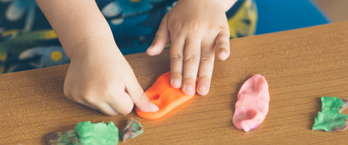 Little girl playing with putty