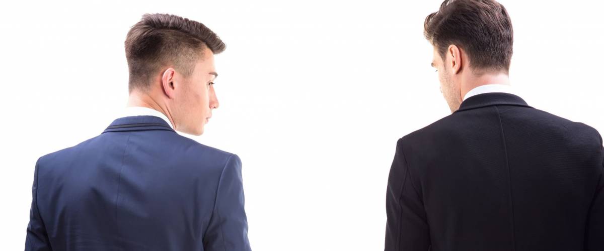 Two young stylish men in a suit. Rear view from the back.