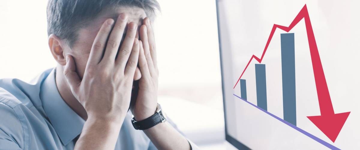 Frustrated stressed shocked business man with financial market chart graphic going down on grey office wall background. Poor economy concept. Face expression, emotion, reaction