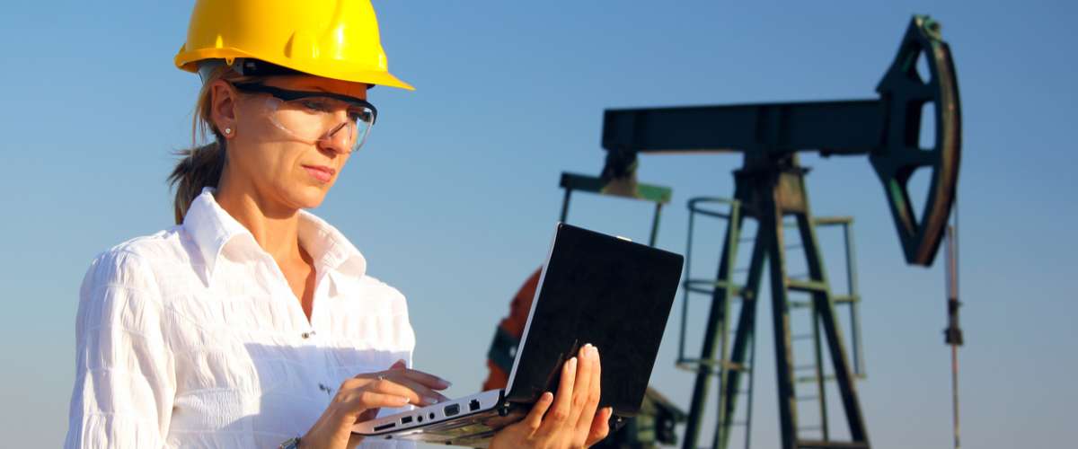 Female engineer in an oilfield working with notebook