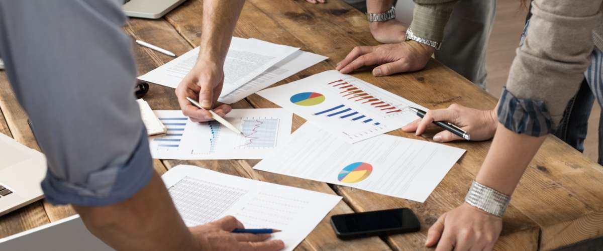 Businessman and woman discussing on stockmarket charts in office