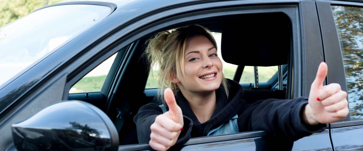 Young girl happy seated in her new car