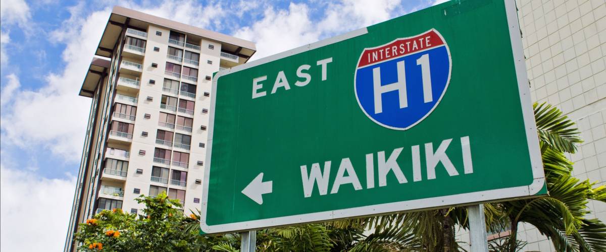 A highway sign points in the direction of Waikiki beach, Oahu, Hawaii.
