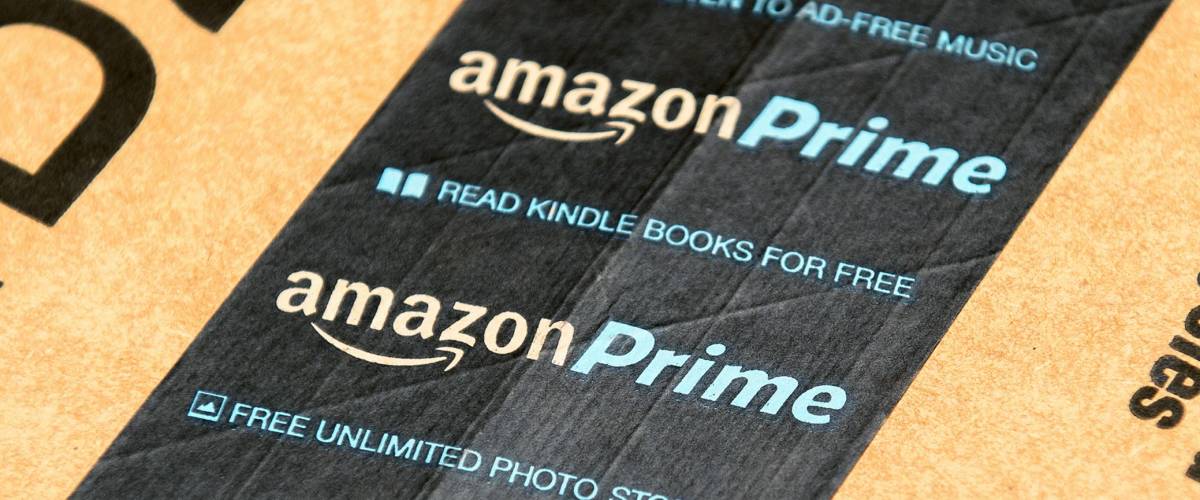 PARIS, FRANCE - JAN 28, 2016: Amazon Prime logotype printed on cardboard box security scotch tape.