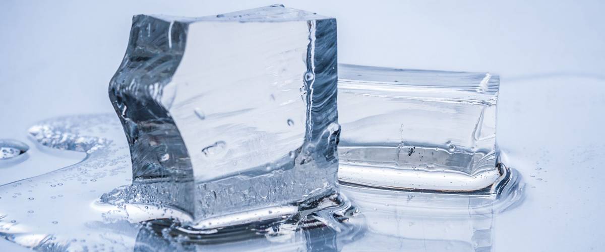 Melting ice cubes on blue background