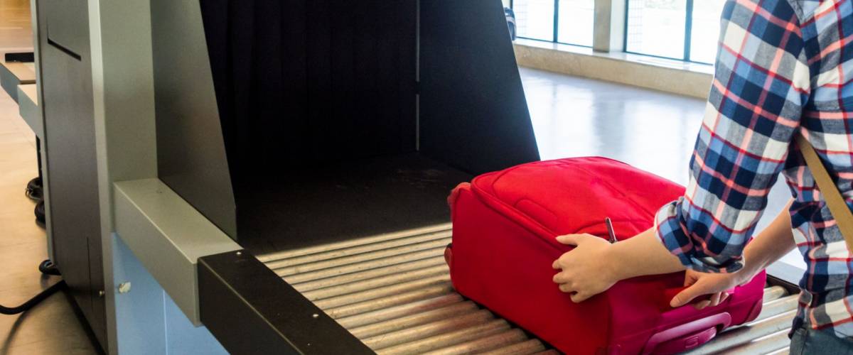 woman traveler selective focus Baggage X-ray machine try to detection metal prevention bad terrorist to attack airplane at the airport before take off.