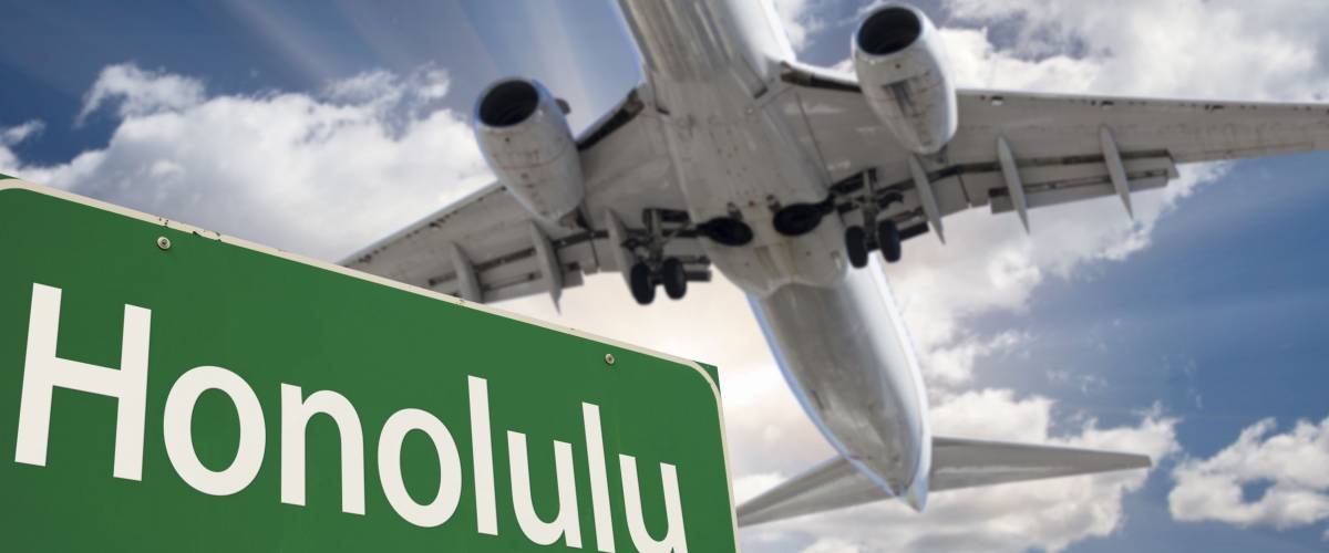 Honolulu Green Road Sign and Airplane Above with Dramatic Blue Sky and Clouds.