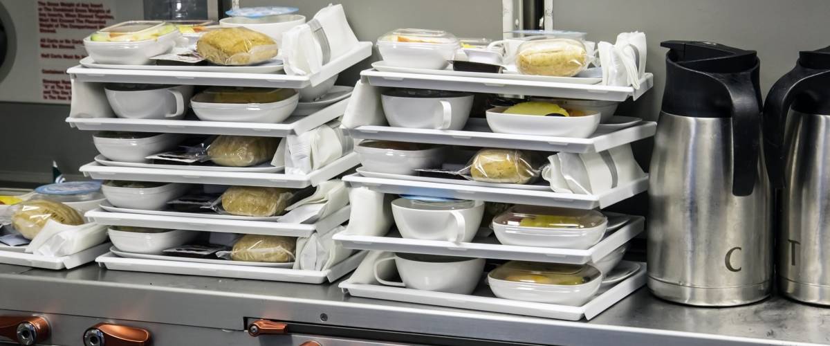 Preparing food for the passengers in the kitchen air plane. Lunch for airline passengers. Dinner menu at airplane. Meals for Aircraft on kitchen.