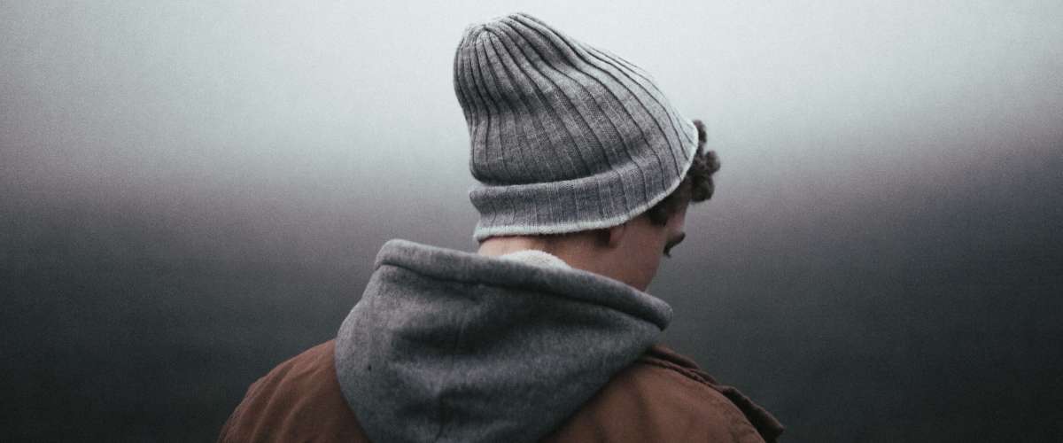 sad young man wearing winter clothing