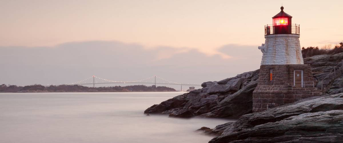 Castle Hill Lighthouse, Rhode Island / Long exposure photo at morning in Newport, Rhode Island, USA on a rocky coastline of the Atlantic ocean. / Castle Hill Lighthouse at Sunrise