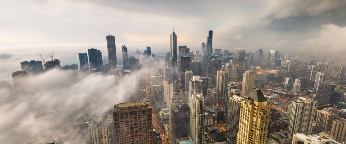 Chicago, Illinois, USA skyline from above with storm clouds and fog rolling in.