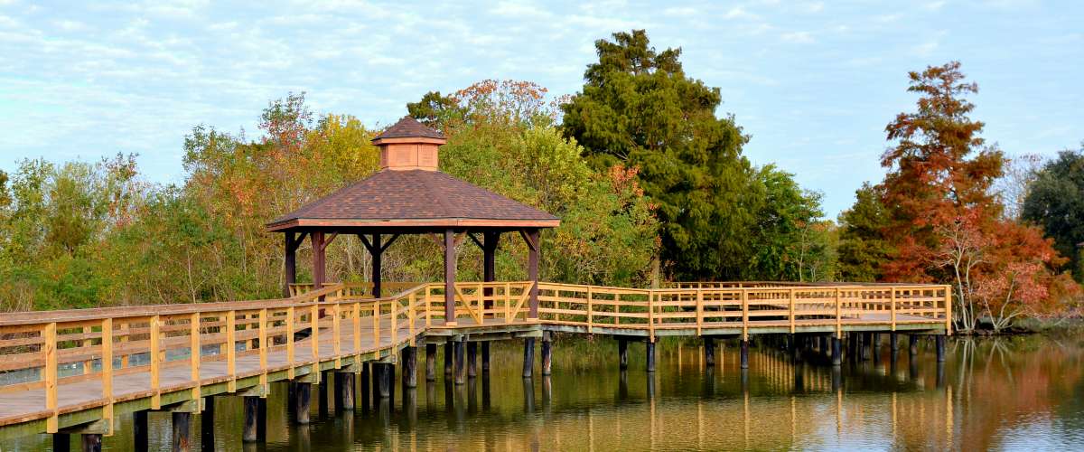 A boardwalk with a gazebo over a southern swamp in Lafreniere Park in Metairie, Louisiana