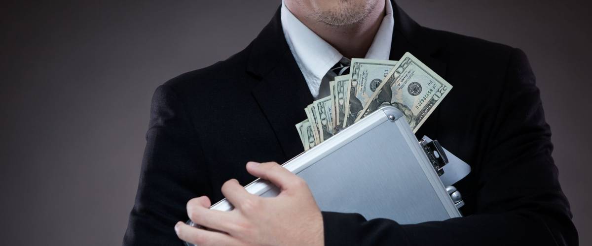 Business man with metal suitcase full of money