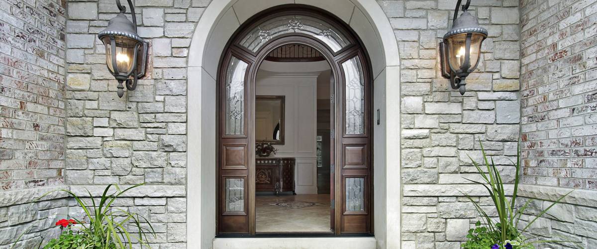 Arched stone entry of luxury suburban home