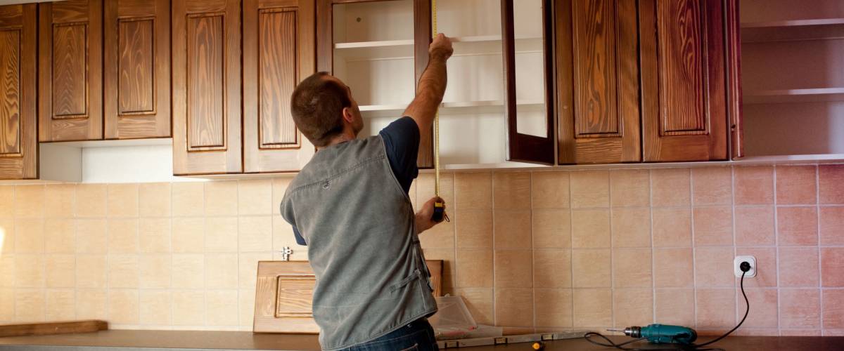 Carpenter working on new kitchen cabinets
