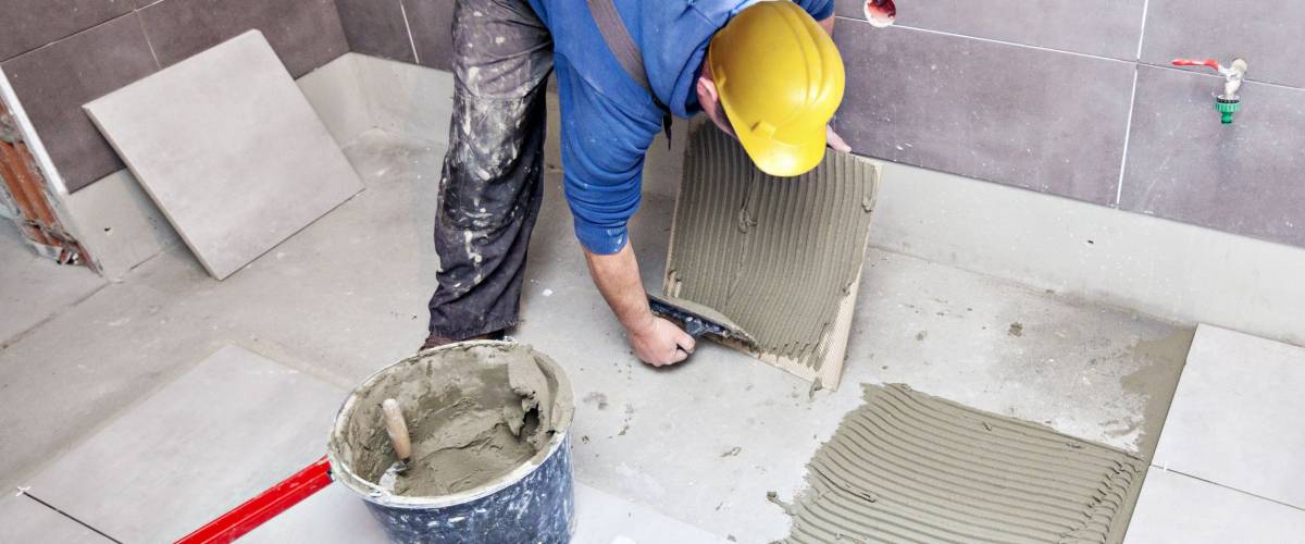 Tiling Floor & Wall. The tiler builder arranges the bathroom ceramics.
