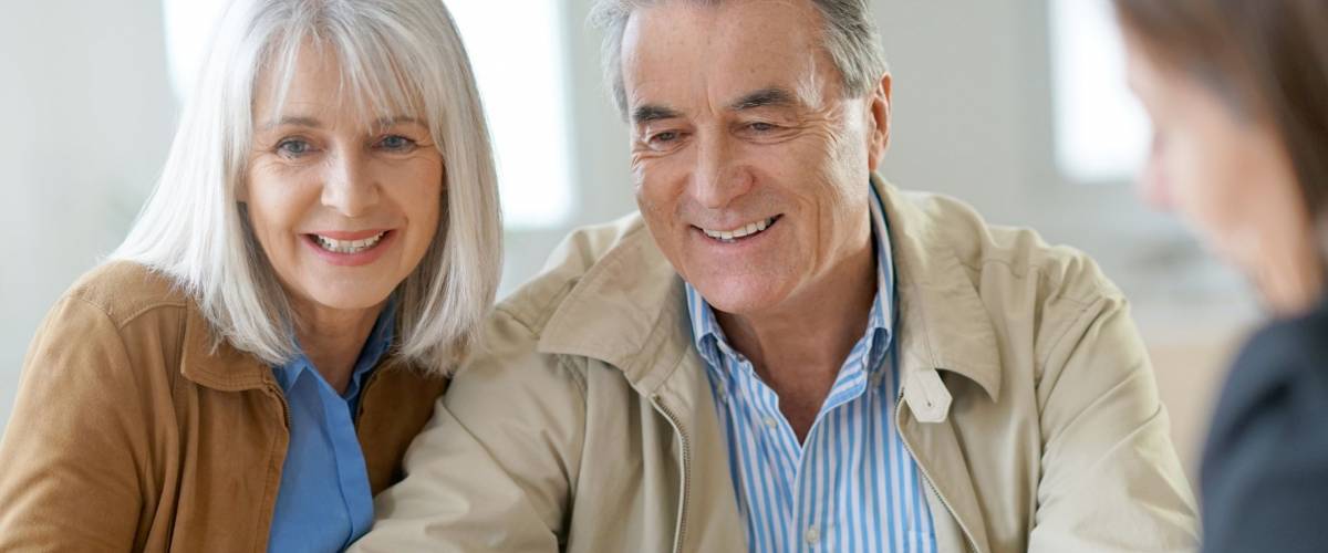 Senior couple meeting financial adviser for investment