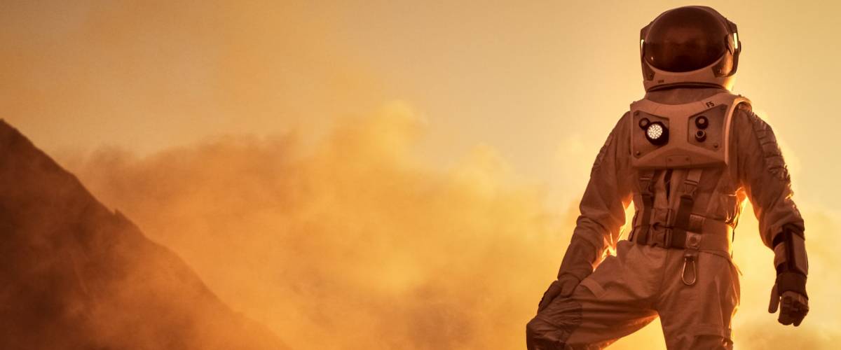 Silhouette of the Astronaut Standing on the Rocky Mountain of the Alien Red Planet/ Mars. First Manned Mission on Mars. Space Exploration, Colonization.