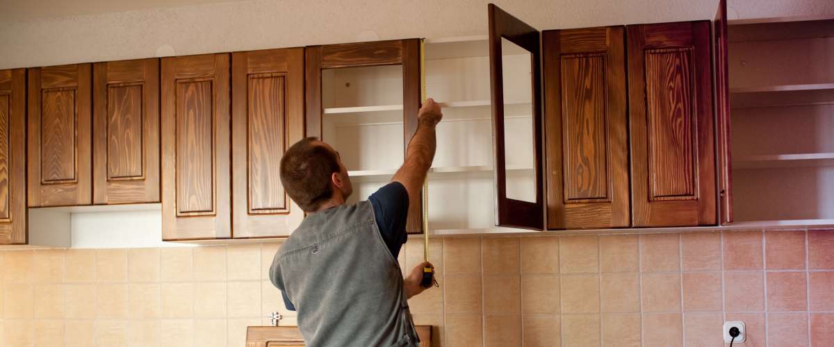 Carpenter working on new kitchen cabinets