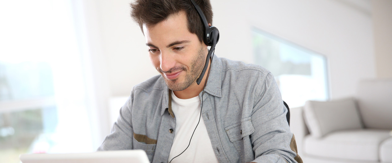 Young man taking phone calls on his headset