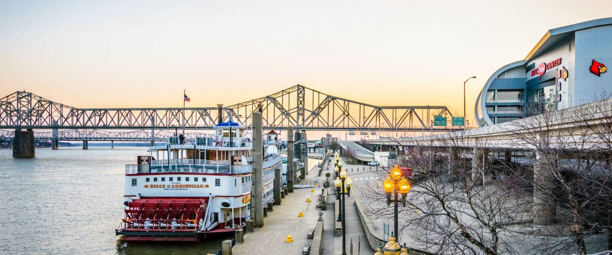 LOUISVILLE, KY, USA - FEB 5, 2017: Sunrise at the Louisville KY Waterfront Park Wharf and the KFC Yum! Center. The wharf is home to the Belle of Louisville Steamboat.