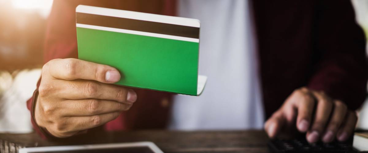 Business man hands holding saving account passbook with calculator, account and saving concept.