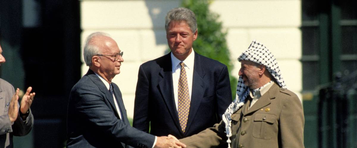 Washington DC. USA, 13th September, 1993Yitzhak Rabin of Israel and Yasser Arafat of the PLO shake hands with President Bill Clinton