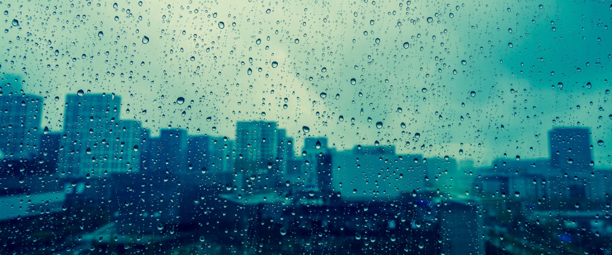City view through a window on a rainy day