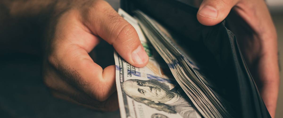 Man looks in the wallet. Cash. Wealthy man counting his money. Close up.