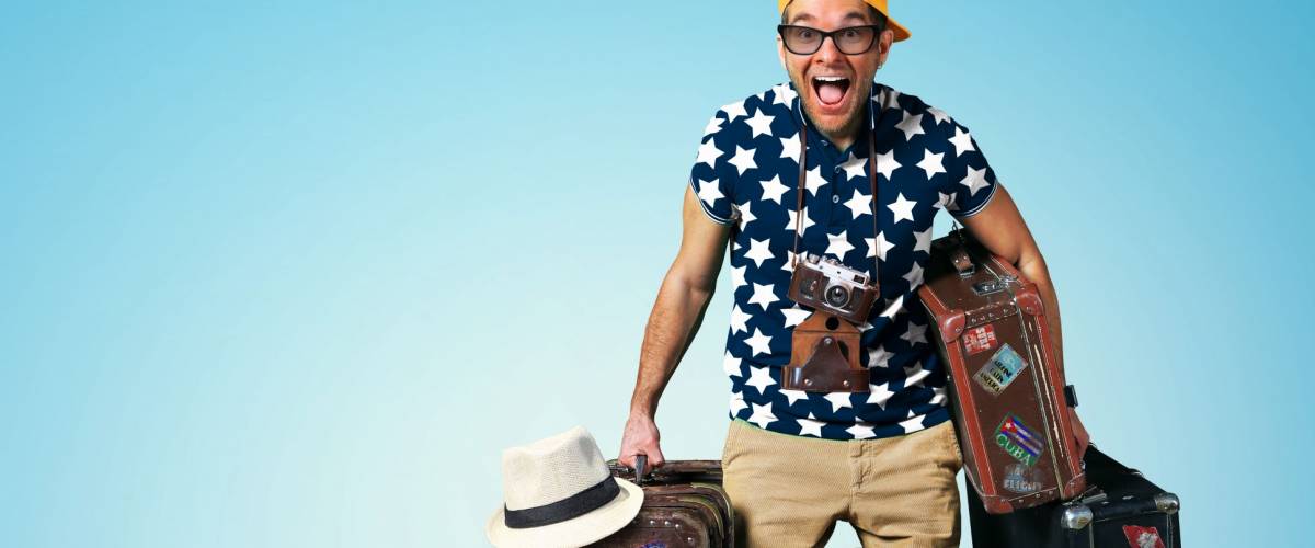 Tourist on vacation with a bunch of old suitcases