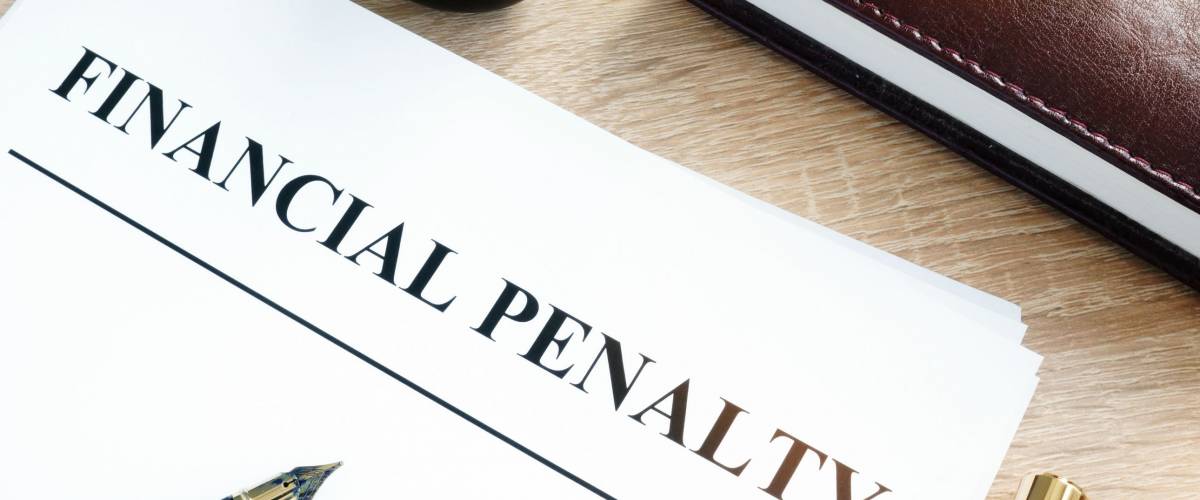 Document with title Financial penalty on a desk.