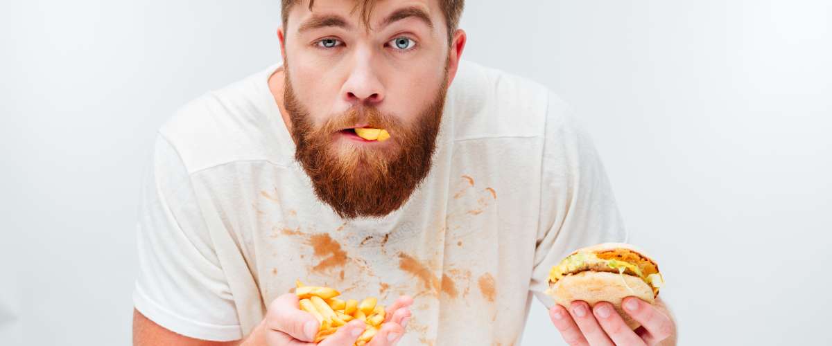 funny hungry bearded man eating messy