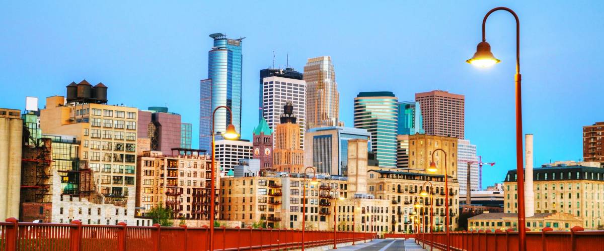 Downtown Minneapolis, Minnesota at night time as seen from the famous stone arch bridge