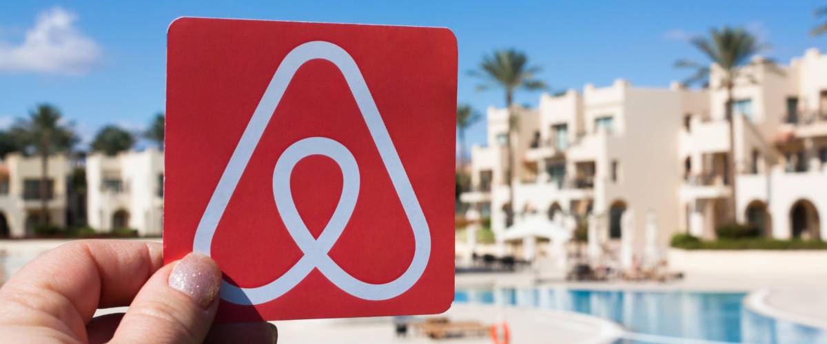 Sharm El Sheikh, Egypt. January, 2018. Travel around the world with Airbnb. Logo Airbnb. House, sea, tree and sky are on the background. Summer travel concept. Rent a house or an apartment.