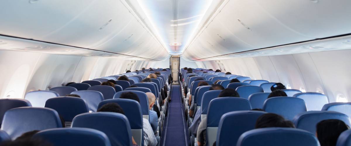 Passengers traveling by a plane, shot from the inside of an airplane